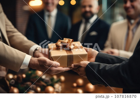 Close-up view of hands Giving a business gift in an office Close-up view of hands Giving a business gift in an office 107816870