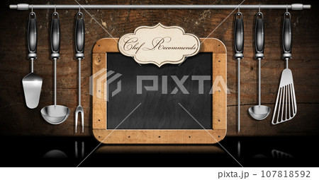 Empty Blackboard with Text Chef Recommends and Kitchen Utensils Empty Blackboard with Text Chef Recommends and Kitchen Utensils 107818592