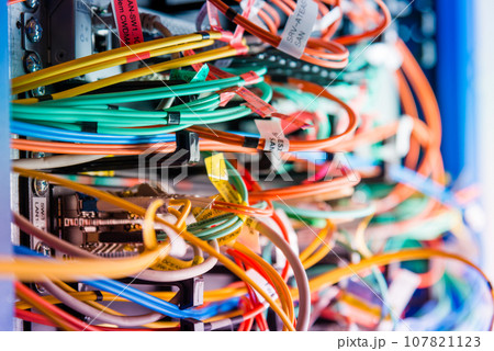 detail of server rack with fiber optic cables attached to front panel switch ports 107821123