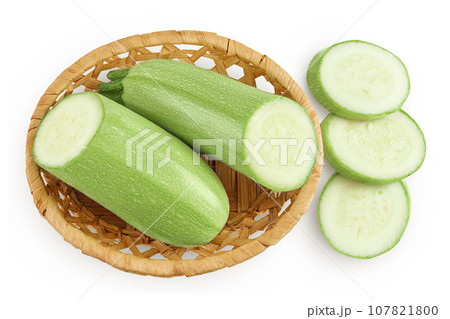 zucchini or marrow in a wicker basket isolated on white background with full depth of field. Top view. Flat lay zucchini or marrow in a wicker basket isolated on white background with full depth of field. Top view. Flat lay 107821800