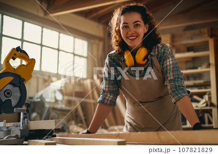 carpenter is working in workshop 107821829