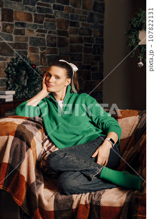 Pensive woman having rest in her forest house during winter holidays 107822131