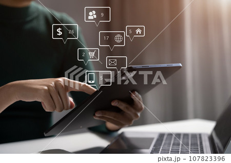 Businesswomen working with smart phone and laptop and digital tablet computer in office with digital marketing media in virtual icon. Businesswomen working with smart phone and laptop and digital tablet computer in office with digital marketing media in virtual icon. 107823396