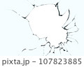 Broken glass with cracks and a big hole. Black cracks on blue glass with a white background. 107823885