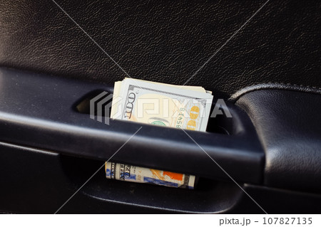 wad of dollars inside the car. wad of dollars inside the car. 107827135