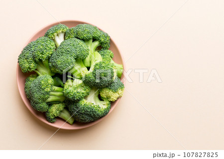 broccoli of fresh green broccoli in bowl over coloredbackground. , close up. Fresh vegetable broccoli of fresh green broccoli in bowl over coloredbackground. , close up. Fresh vegetable 107827825
