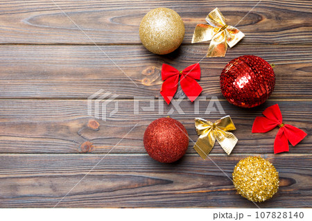 Top view of Christmas balls and creative decorations on wooden background with copy space. New Year concept Top view of Christmas balls and creative decorations on wooden background with copy space. New Year concept 107828140