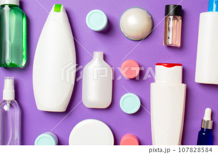 Group of plastic bodycare bottle Flat lay composition with cosmetic products on colored background empty space for you design. Set of White Cosmetic containers, top view with copy space 107828584