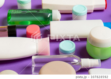 Top view of different cosmetic bottles and container for cosmetics on colored background. Flat lay composition with copy space Top view of different cosmetic bottles and container for cosmetics on colored background. Flat lay composition with copy space 107828592