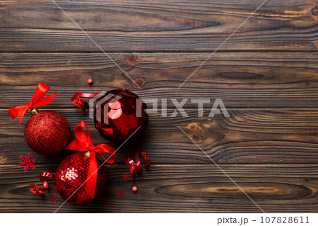 Christmas ball on colored background. decoration bauble with ribbon bow with copy space 107828611