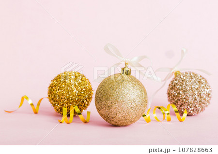 Christmas ball on colored background. decoration bauble with ribbon bow with copy space Christmas ball on colored background. decoration bauble with ribbon bow with copy space 107828663