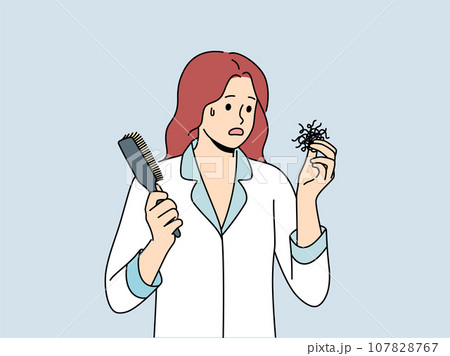 Woman suffering from hair loss problems holds comb and feels confused and needs help doctor 107828767