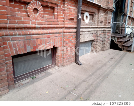 upper part of the window of the ground floor of the building. Recessed windows of ancient buildings of the 19th century. 107828809