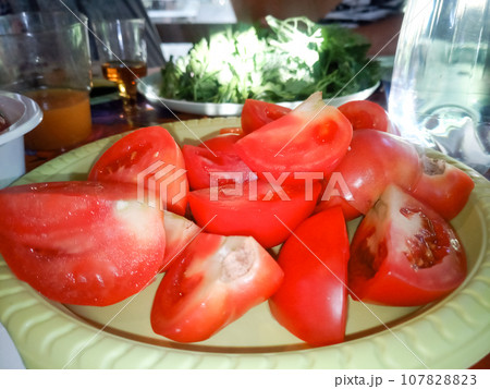 Tomato salad on a plate in dining room. Vegetable salad. 107828823