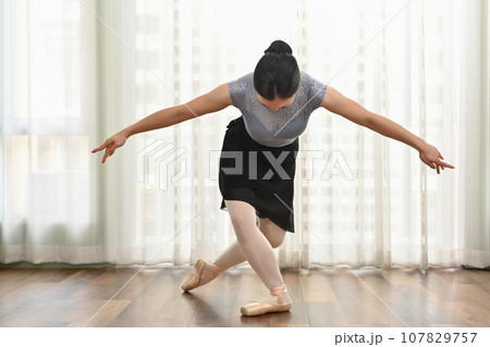 Pretty young ballerinas practicing ballet positions in studio. Dance, art and active lifestyle concept Pretty young ballerinas practicing ballet positions in studio. Dance, art and active lifestyle concept 107829757