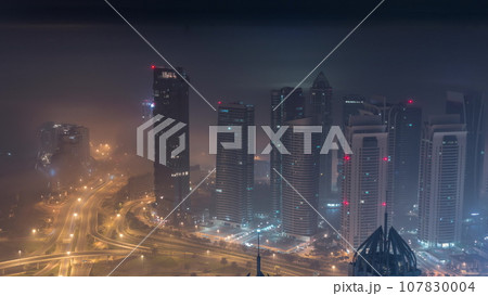 JLT and Dubai marina skyscrapers near Sheikh Zayed Road aerial all night timelapse. Residential buildings JLT and Dubai marina skyscrapers near Sheikh Zayed Road aerial all night timelapse. Residential buildings 107830004