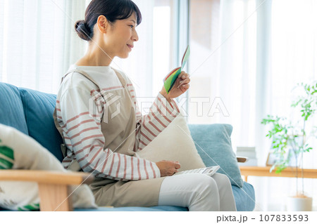 通帳を見る主婦 通帳を見る主婦 107833593