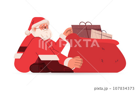 santa claus in red costume sitting on floor near sack full of gift boxes happy new year merry christmas holidays celebration concept 107834373