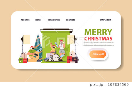 disabled man photographer in santa claus christmas hat doing photo of models with replaced robotic body parts in photo studio people with disabilities disabled man photographer in santa claus christmas hat doing photo of models with replaced robotic body parts in photo studio people with disabilities 107834569