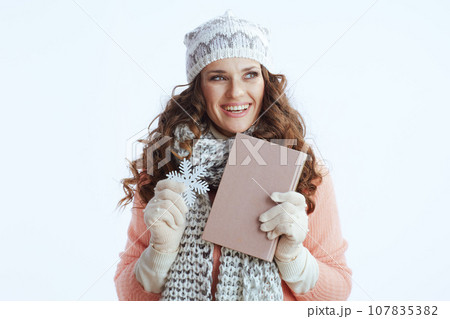 smiling stylish woman in sweater, mittens, hat and scarf smiling stylish woman in sweater, mittens, hat and scarf 107835382