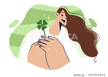 Woman holds four-leaf clover petal and rejoices at approaching holiday of St. Patrick day Woman holds four-leaf clover petal and rejoices at approaching holiday of St. Patrick day 107835821