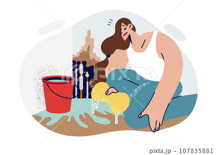 Woman eliminates consequences water supply accident or pipe break and wipes floor flooded 107835881