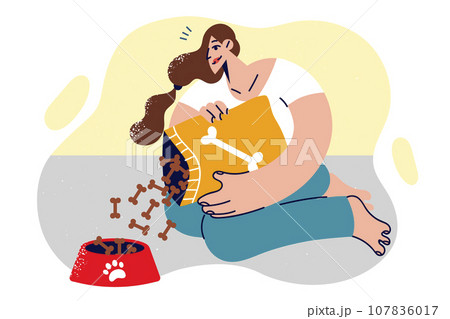 Woman pours dry nutrition into dog bowl, recommending feeding puppies special food 107836017