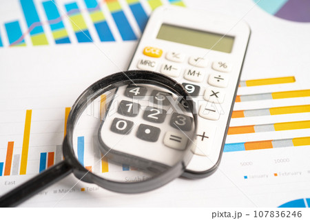 Calculator on chart graph paper. Finance, account, statistic, investment data economy, stock exchange business. 107836246