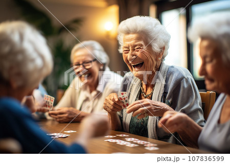Seniors Find Joy in Playing Cards, Sharing Laughter, and Building Camaraderie in a Warm Retirement Nursing Home Atmosphere. created with Generative AI 107836599
