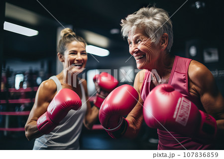 Age-Defying Strength A Senior Woman Boxer, Showcasing Vitality and Resilience, Engages in Training with Her Coach, Confidently Breaking Stereotypes Through Active Exercise. created with Generative AI 107836859