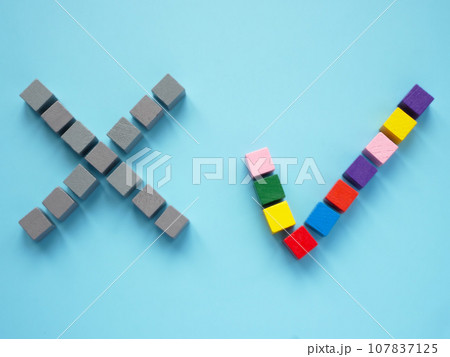A no sign made of gray cubes and yes sign made of multi-colored ones as a concept of inclusion. 107837125