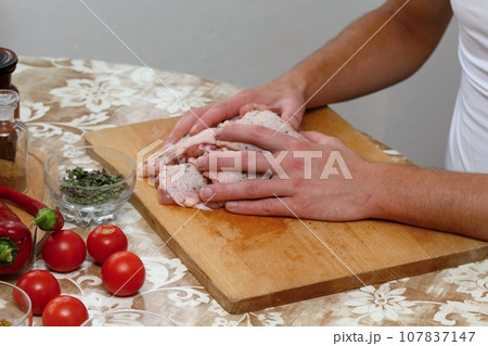 Man's hands and raw chicken meat Man's hands and raw chicken meat 107837147
