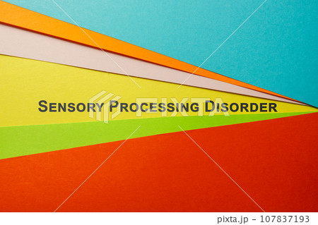 Sheets of colored paper and sign Sensory Processing Disorder SPD. 107837193