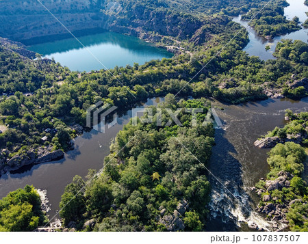 Radon lake near the Southern Bug river on a sunny summer day. Picturesque landscape from a bird's eye view. Flooded granite quarry. 107837507