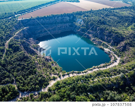 Black or Radon Lake in the Nikolaev region of Ukraine from a bird's eye view. Flooded granite quarry, aerial view, landscape. 107837508
