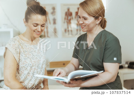 happy female massage therapist conduct educational training 107837514