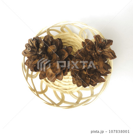 pinecones on a rattan basket pinecones on a rattan basket 107838001