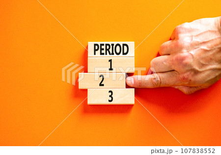 Time to period 2 symbol. Concept word Period 1 2 3 on wooden block. Businessman hand. Beautiful orange table orange background. Business planning and time to period 2 concept. Copy space. 107838552