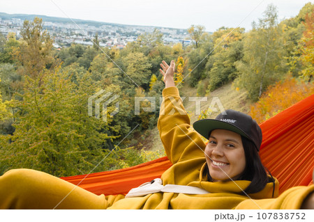 chilling woman laying down in hammock chilling woman laying down in hammock 107838752