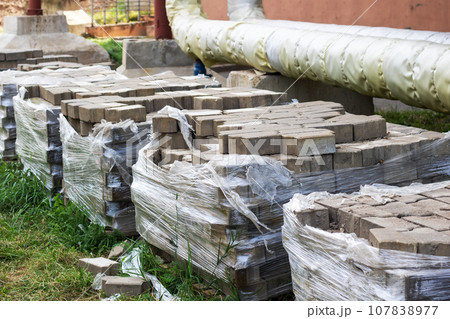 Packaging of paving slabs on the construction site Packaging of paving slabs on the construction site 107838977