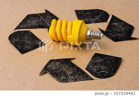 LED light bulb with recycle symbol on craft paper LED light bulb with recycle symbol on craft paper 107839462