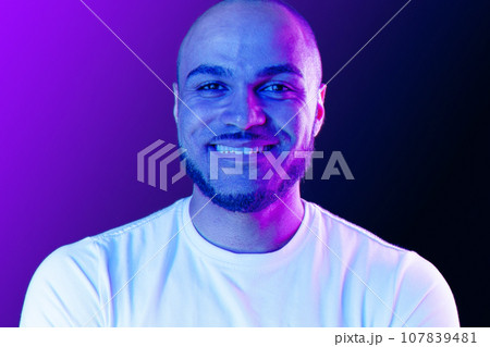Close up portrait of a black man in purple neon light 107839481