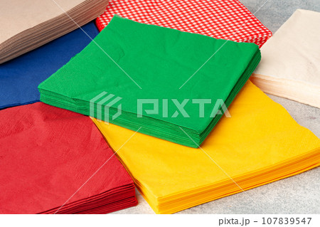 Stacks of colorful paper napkins on gray background 107839547
