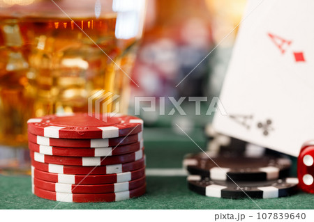 Cards, playing chips and alcohol in glass Cards, playing chips and alcohol in glass 107839640