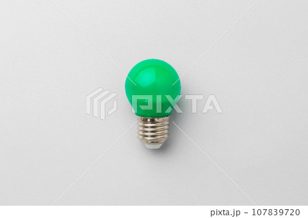 Light bulb on light grey paper background 107839720