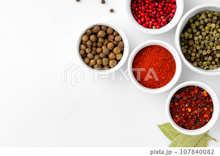 Various spices in a bowls on white background 107840082