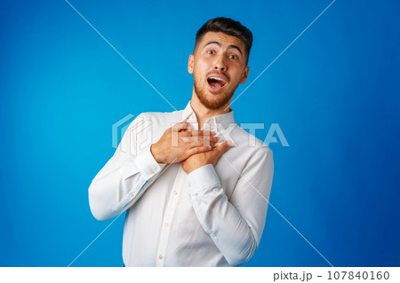 Amazed and confused bearded young man looks with astonishment. 107840160