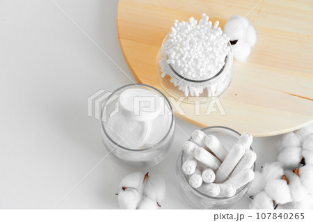 Cotton tampons and ear buds on paper background 107840265