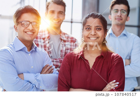 Theyre all about their business. Shot of a group of businesspeople standing in an office at work. Theyre all about their business. Shot of a group of businesspeople standing in an office at work. 107840517