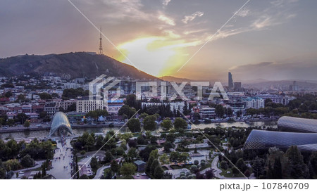 Fantastic drone point of view on Tbilisi cityscape with Kura river ,Bridge of Peace, Rike park and President building in sunrise Fantastic drone point of view on Tbilisi cityscape with Kura river ,Bridge of Peace, Rike park and President building in sunrise 107840709